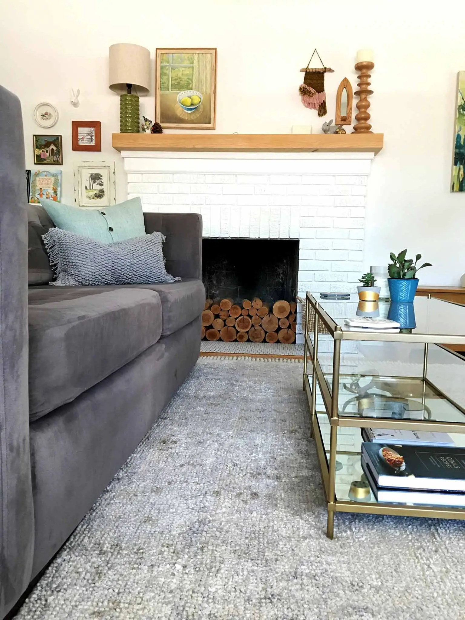 Living room after the refresh | layered rugs, glass coffee table, textured throw pillows, succulents | That Homebird Life Blog