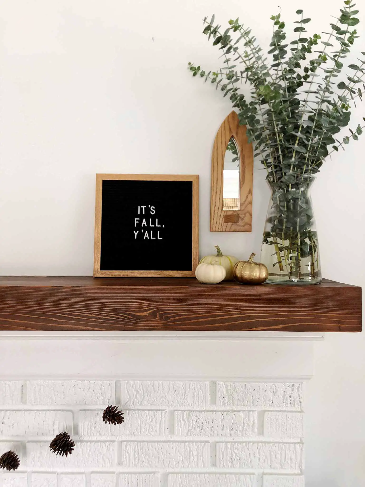 Fall mantel using pinecones, pumpkins, a letterboard and eucalyptus - Simple Fall Decor for the Uncluttered Home - That Homebird Life blog