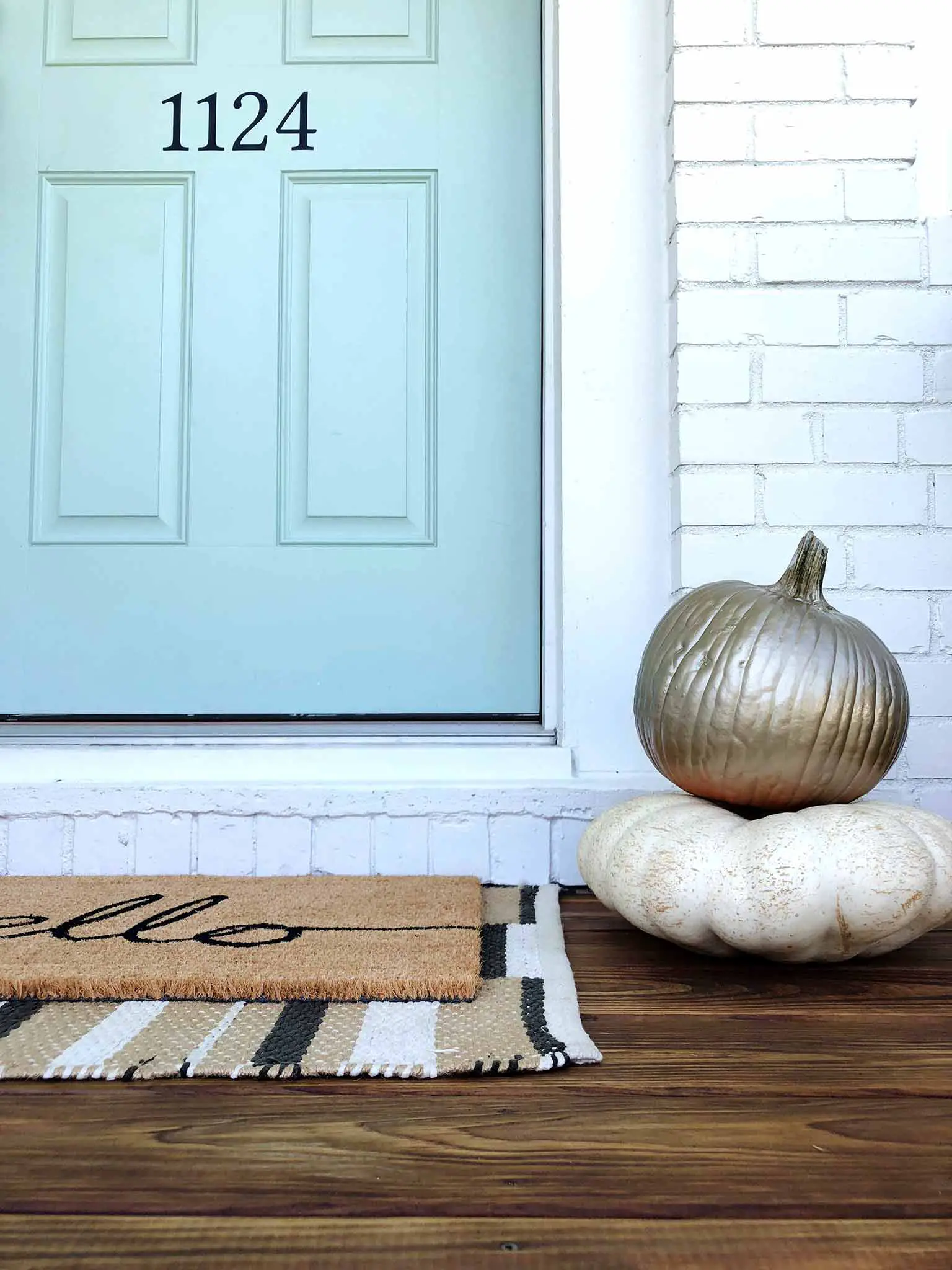 Stacked pumpkins with gold spray paint - Front porch fall makeover reveal - That Homebird Life Blog
