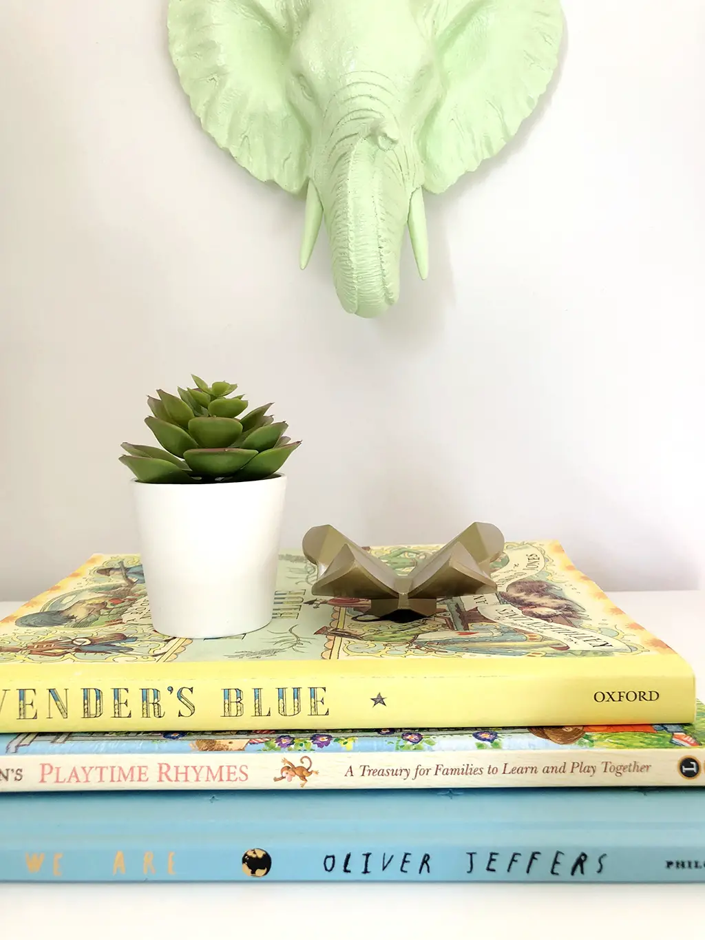 stack of books with faux plant