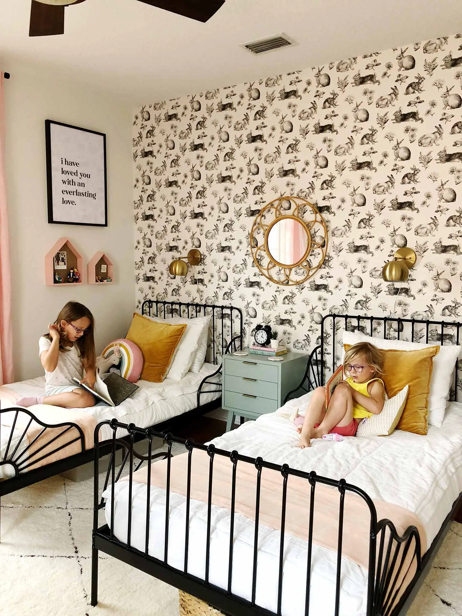 shared girls' bedroom with twin beds and rabbit wallpaper