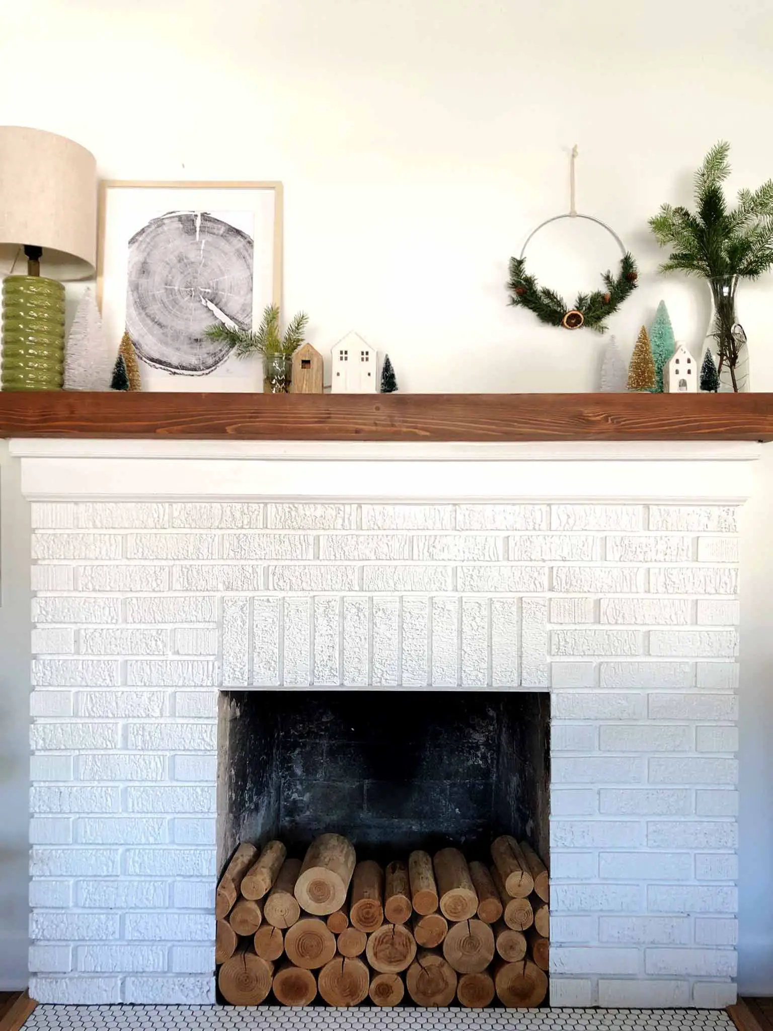 painted white brick fireplace with wood mantel