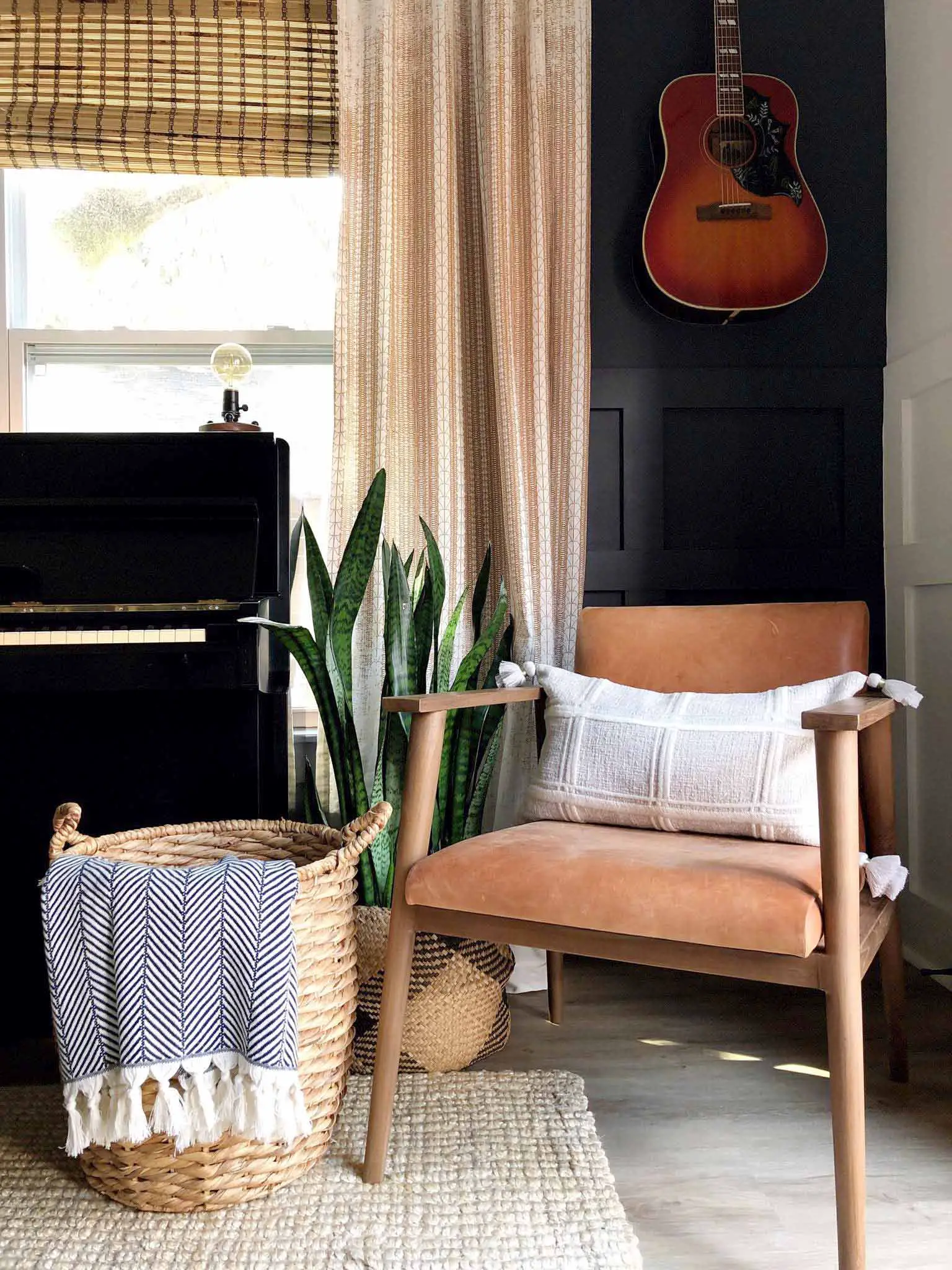chair in corner with guitar on the wall