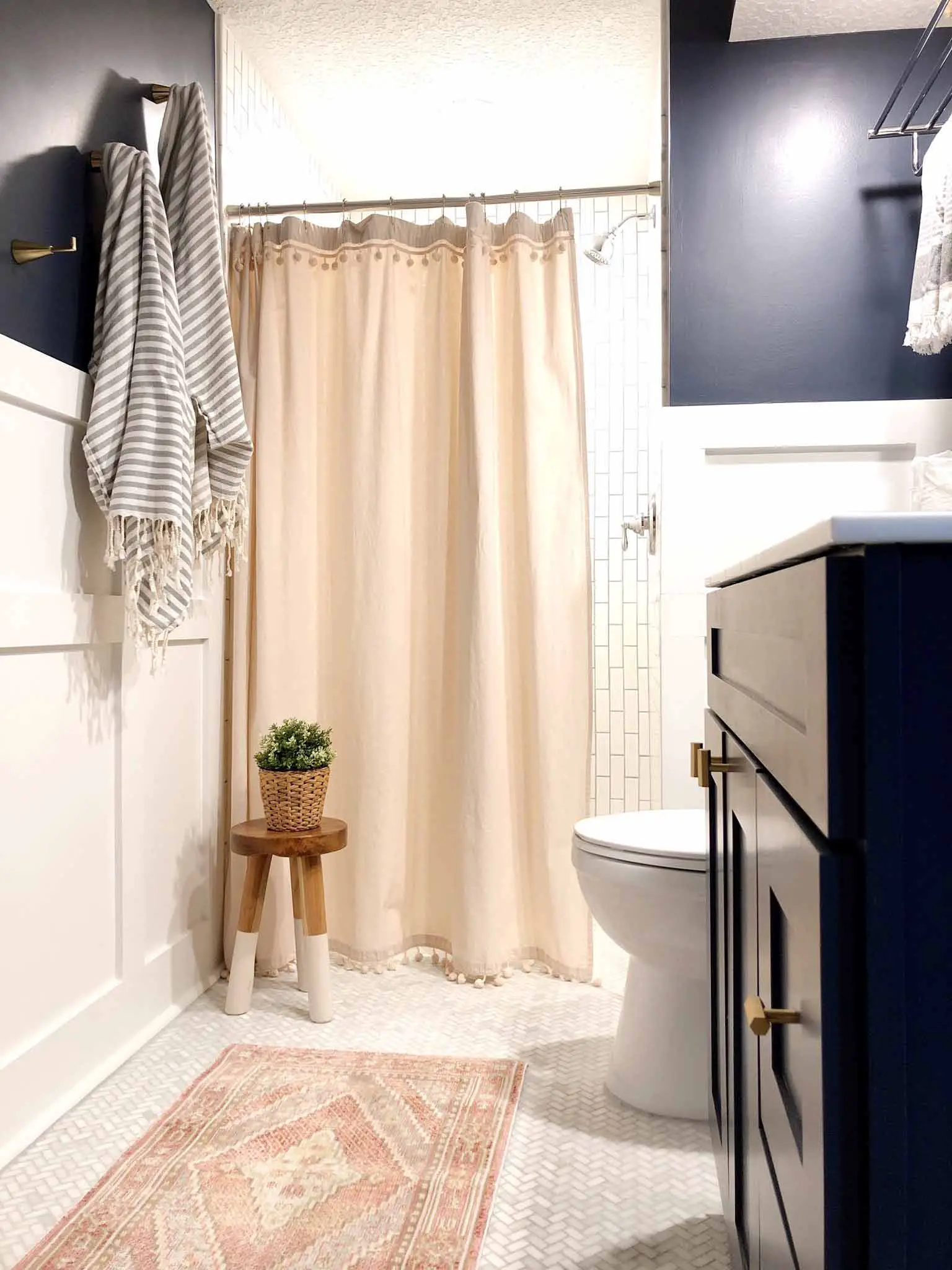 navy and pink bathroom with white tile