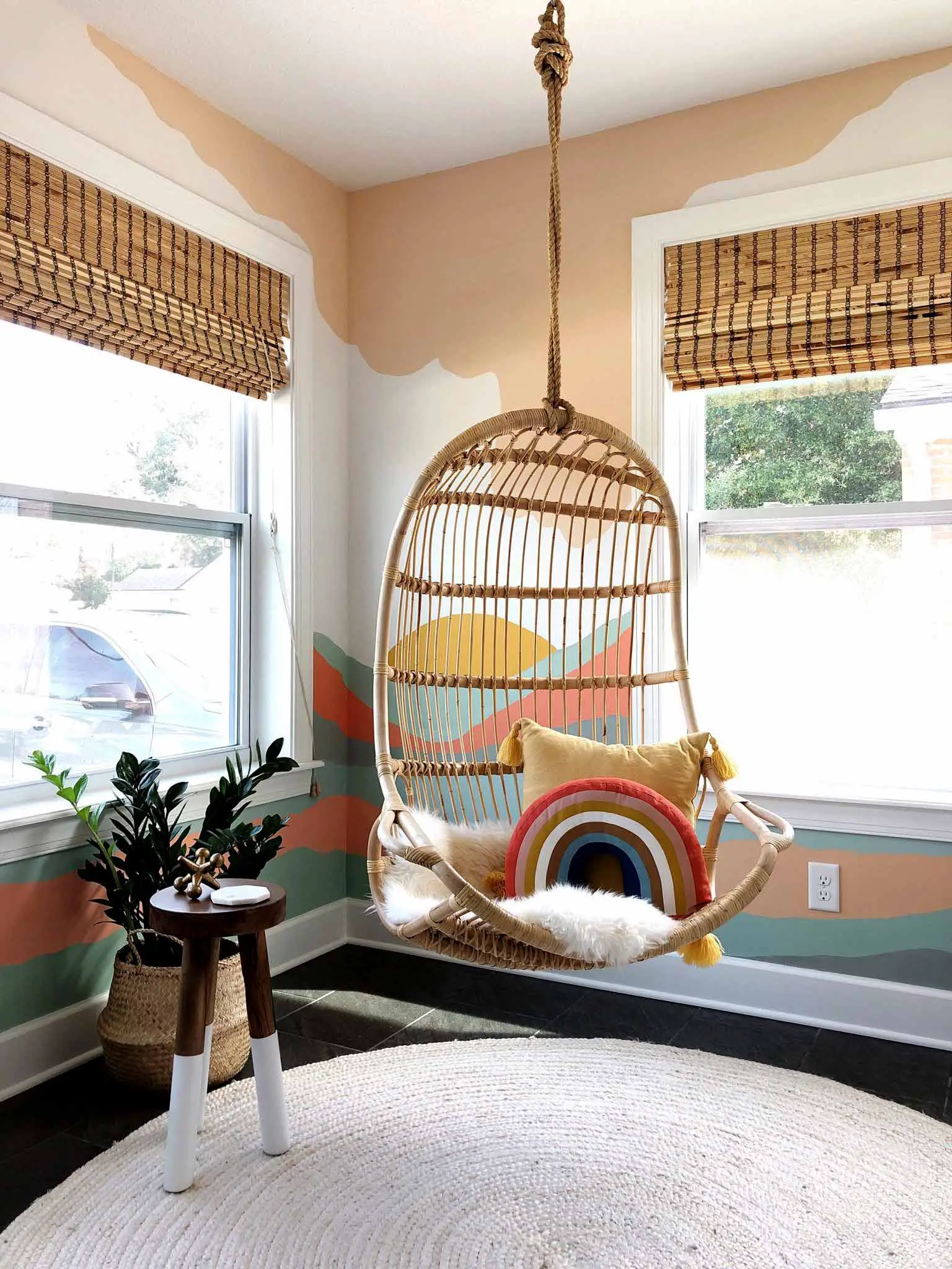 playroom with hanging chair and mural