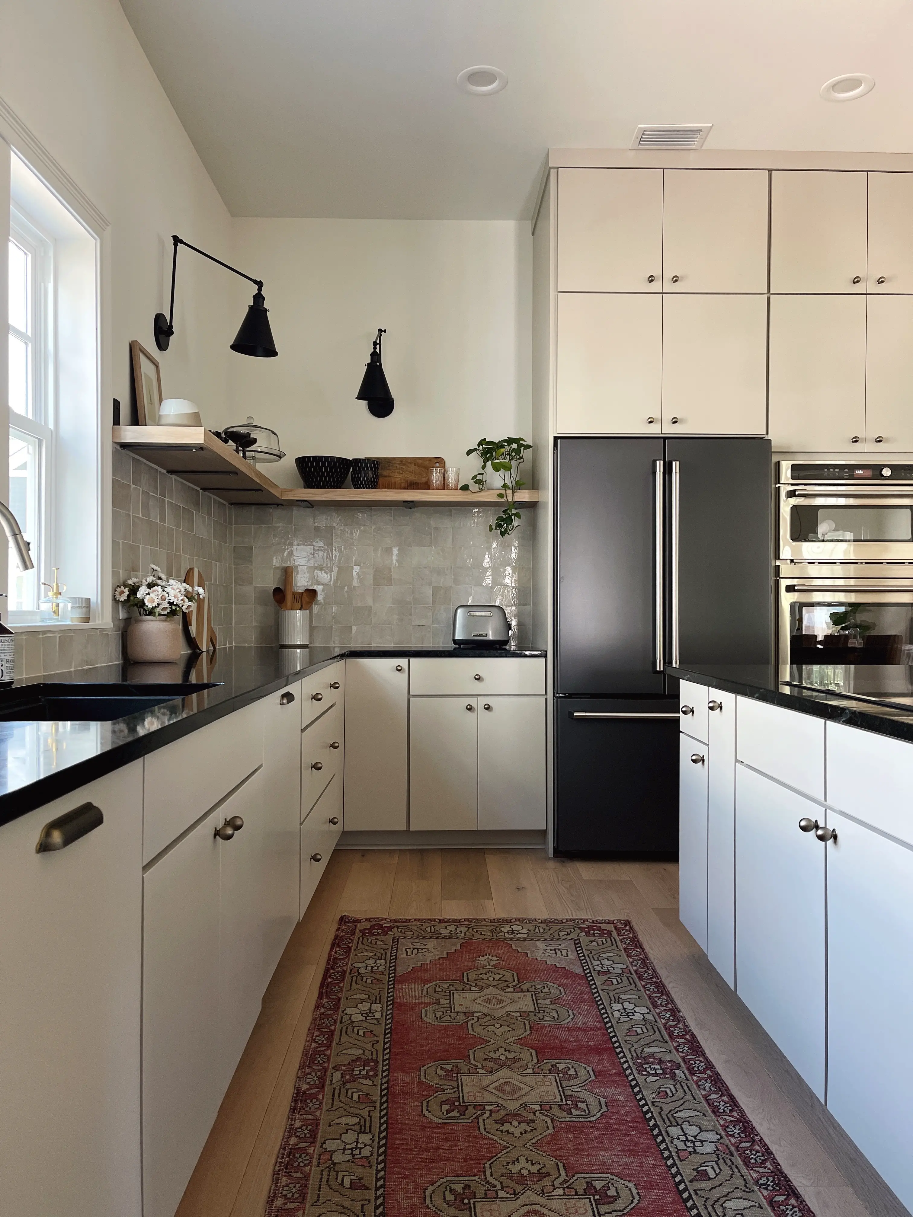 organic modern style kitchen with greige cabinets and soapstone countertops