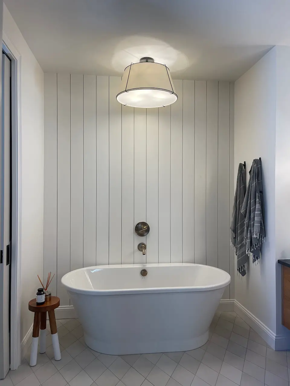 bath tub with shiplap accent wall