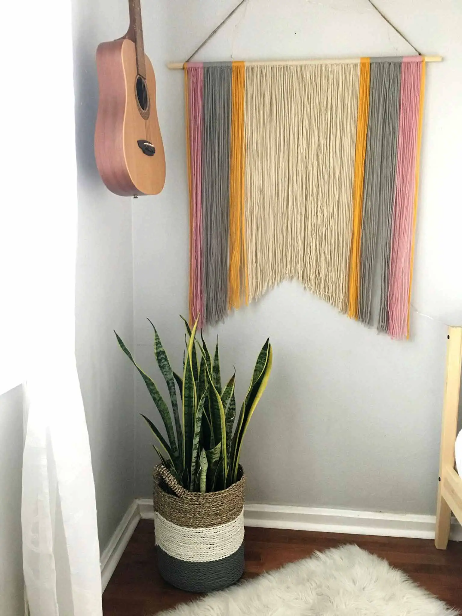 Yarn art and guitar hanging on the wall - modern boho tween bedroom - That Homebird Life Blog