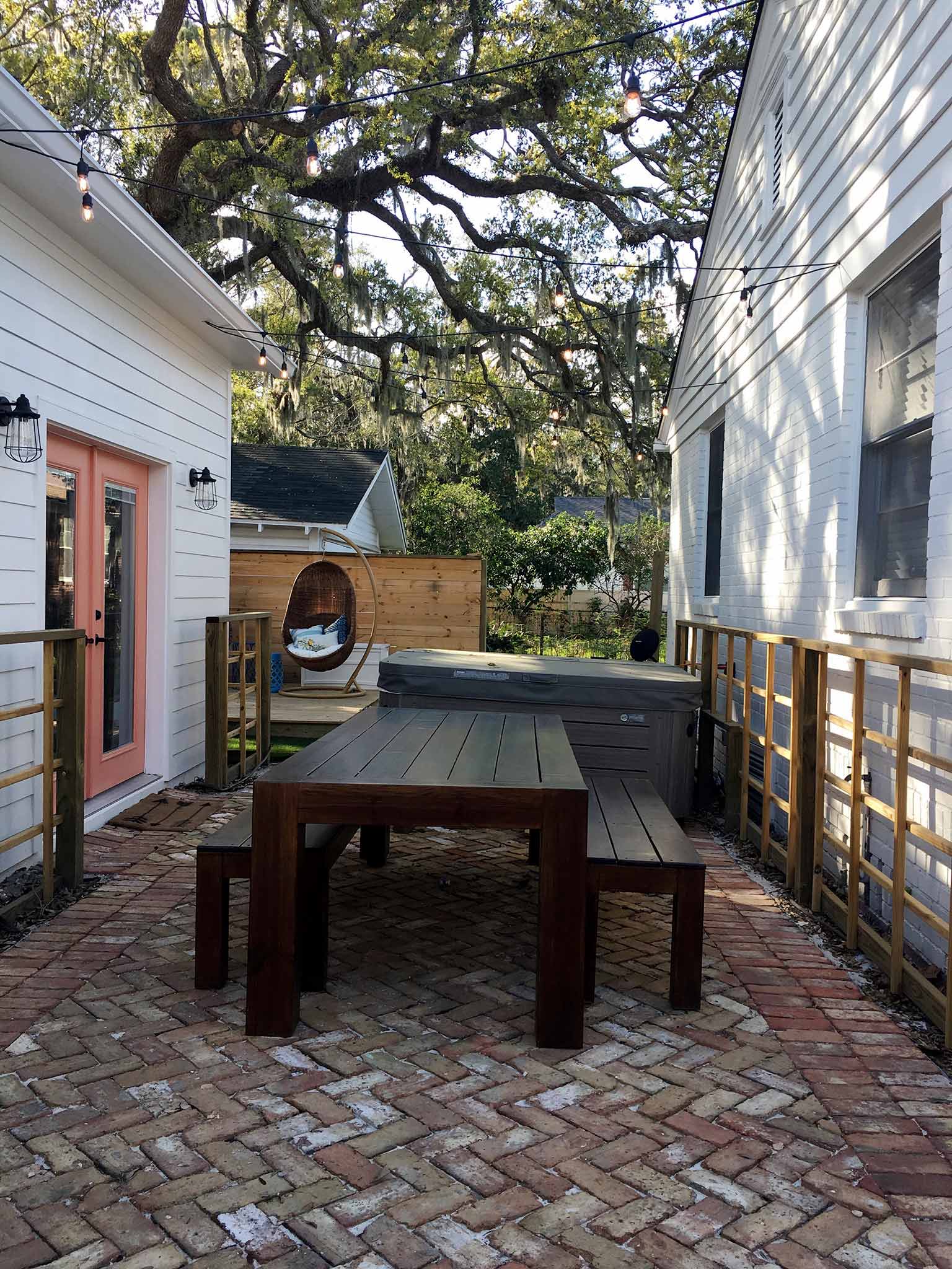 Dining area with reclaimed brick paver patio and string lights - How we planned our backyard space - That Homebird Life Blog