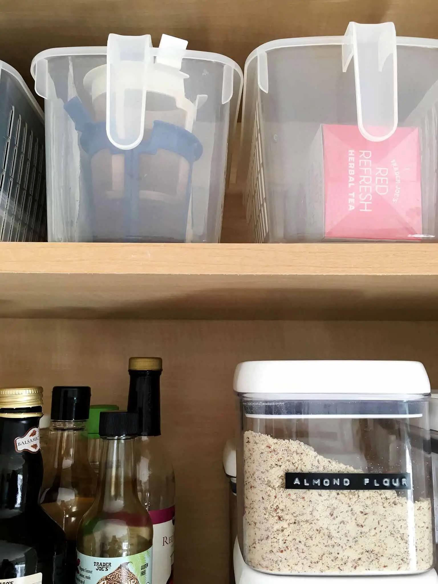 Organized kitchen cabinet with handled storage baskets - That Homebird Life Blog