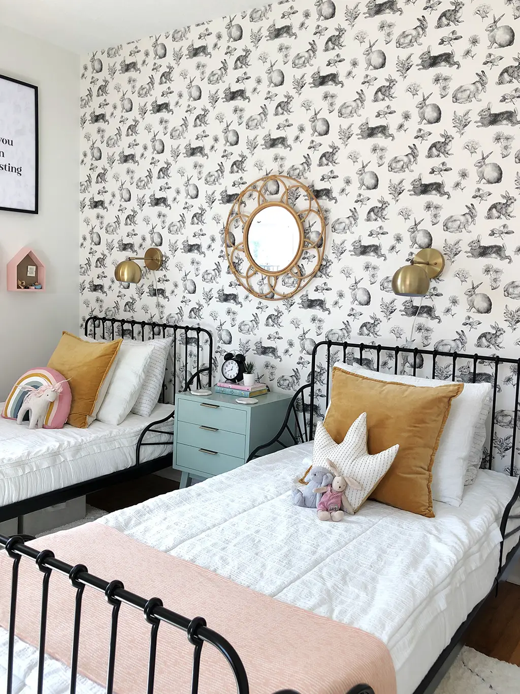 shared girls' bedroom with twin beds and rabbit wallpaper