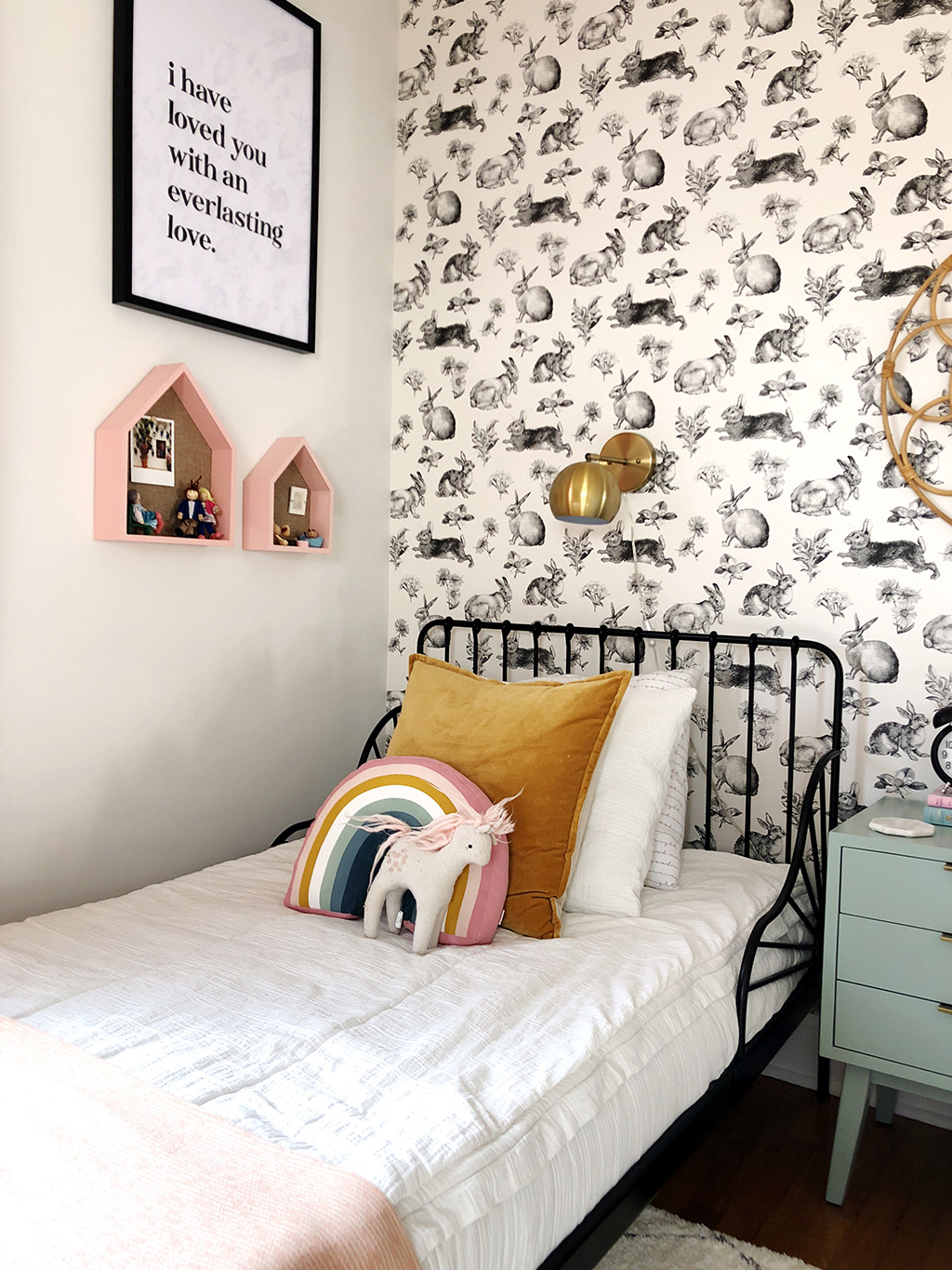 twin bed with white bedding and rabbit wallpaper