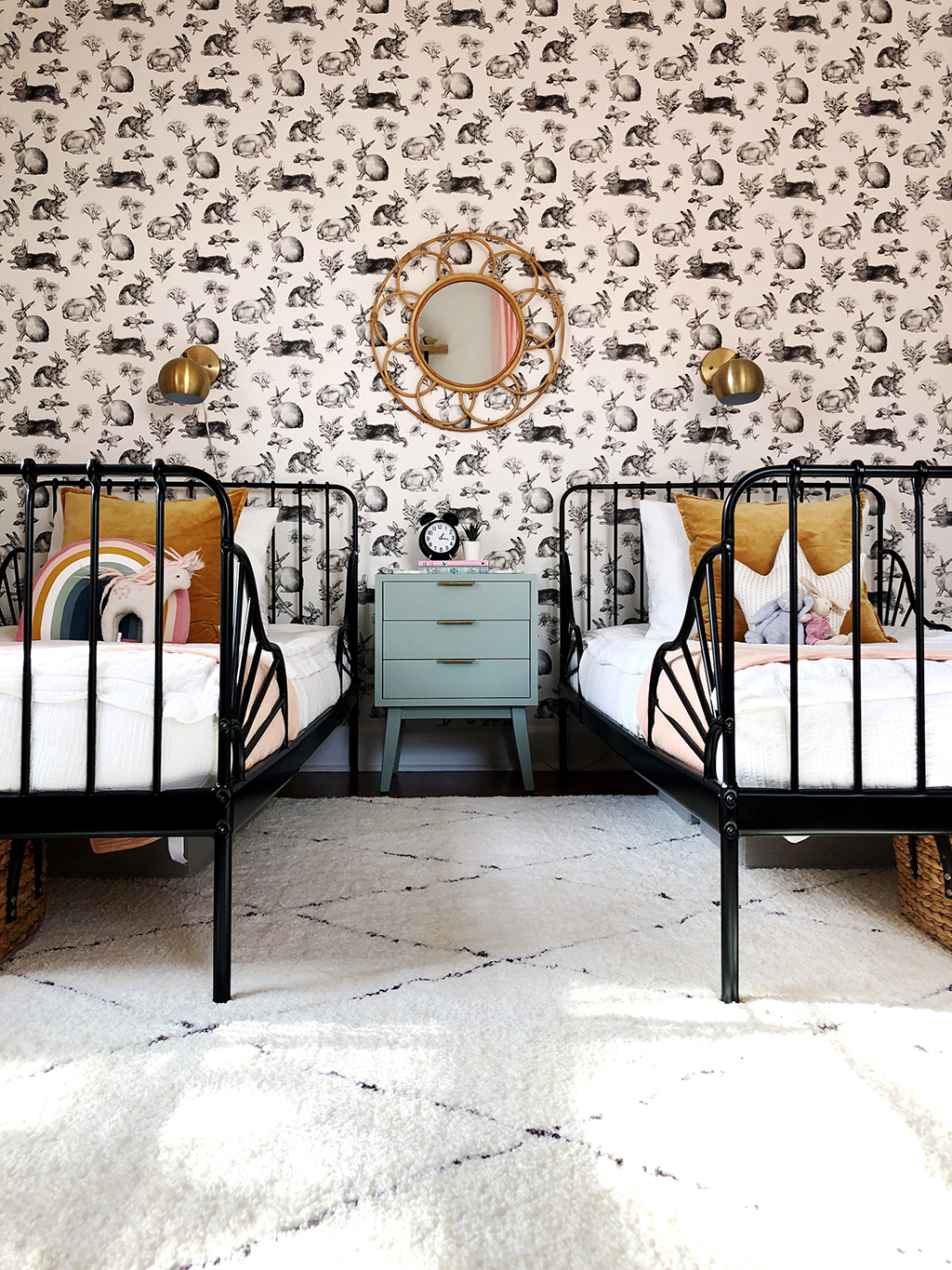 shared girls' bedroom with twin beds and rabbit wallpaper