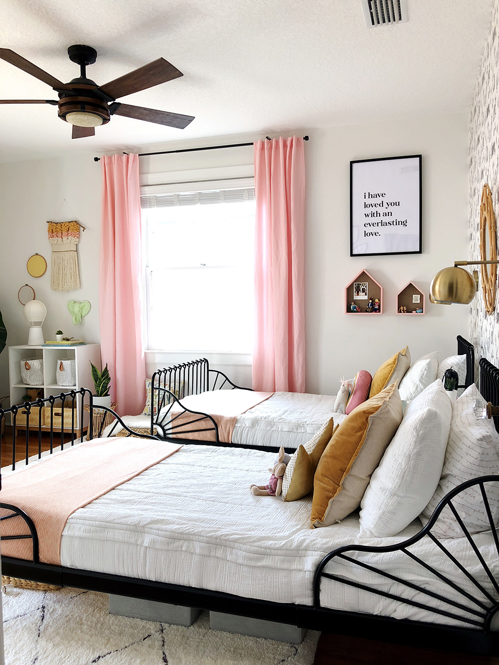 twin beds with white bedding and rabbit wallpaper