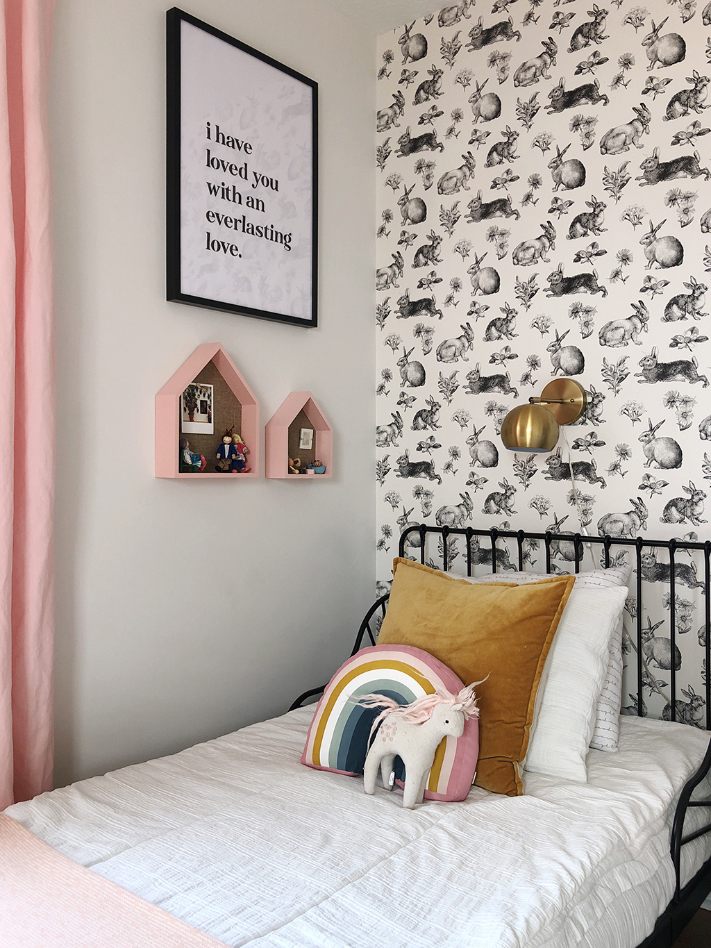 shared girls' bedroom with twin beds and rabbit wallpaper