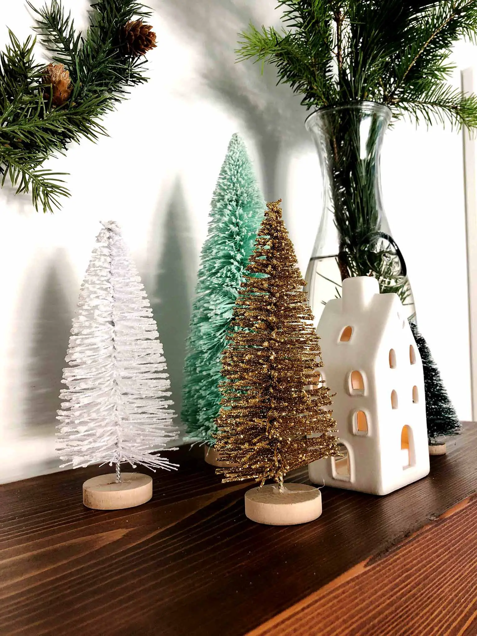 Mantel with bottle brush trees and ceramic house - Simple Yet Cozy Christmas Decor - That Homebird Life Blog #christmasdecor #christmasinspiration