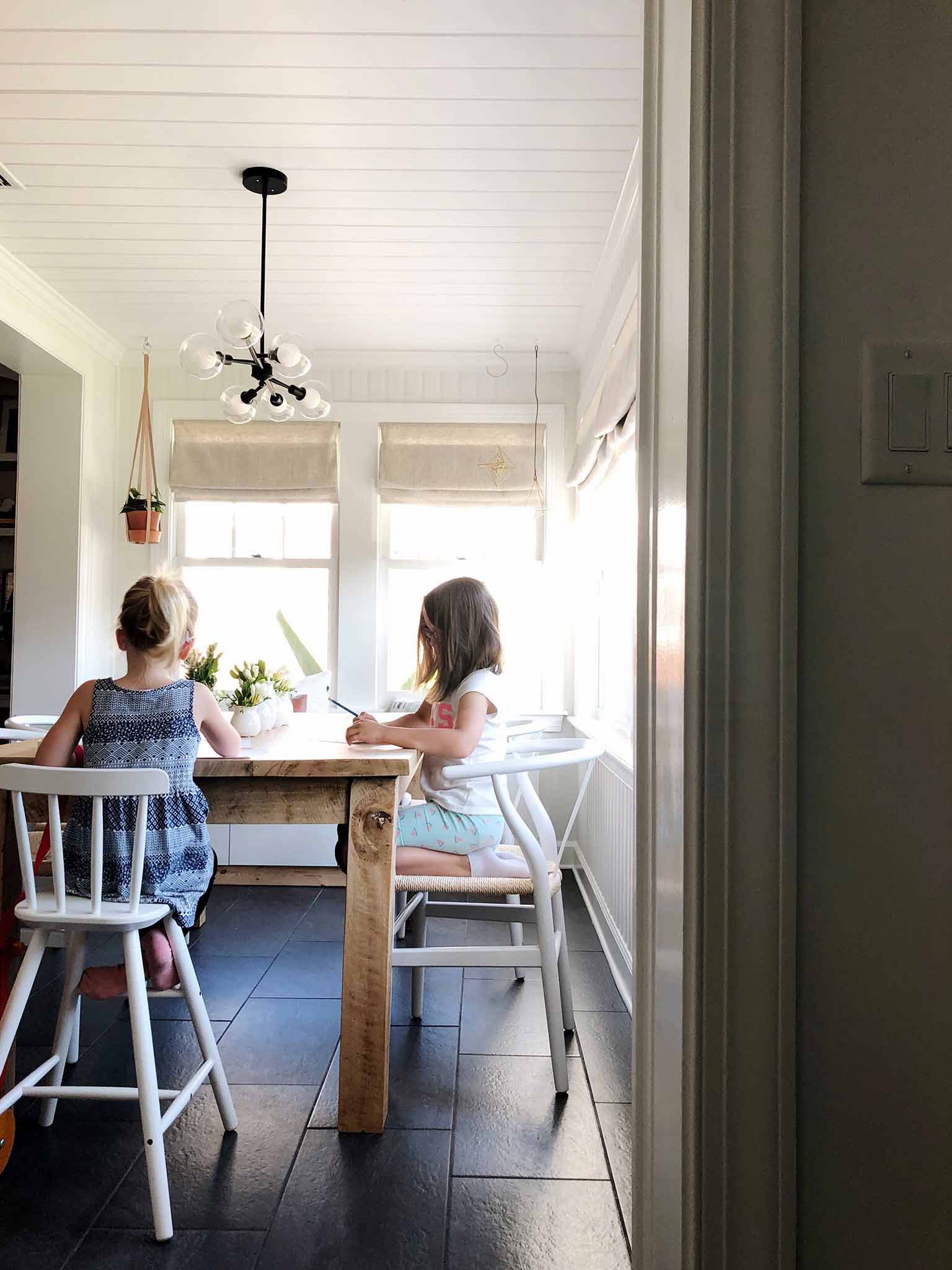 girls sitting at dining room table