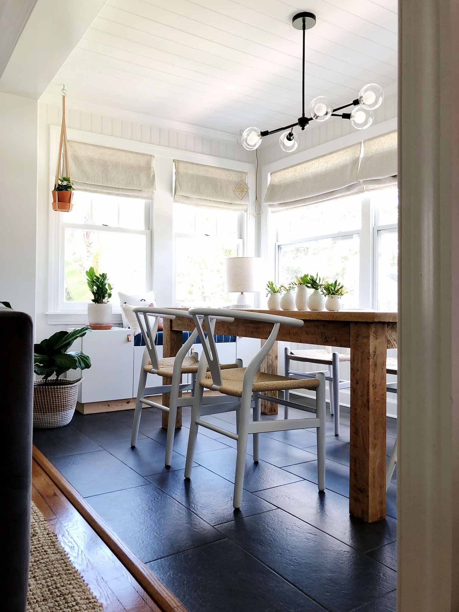 neutral dining room with globe chandelier