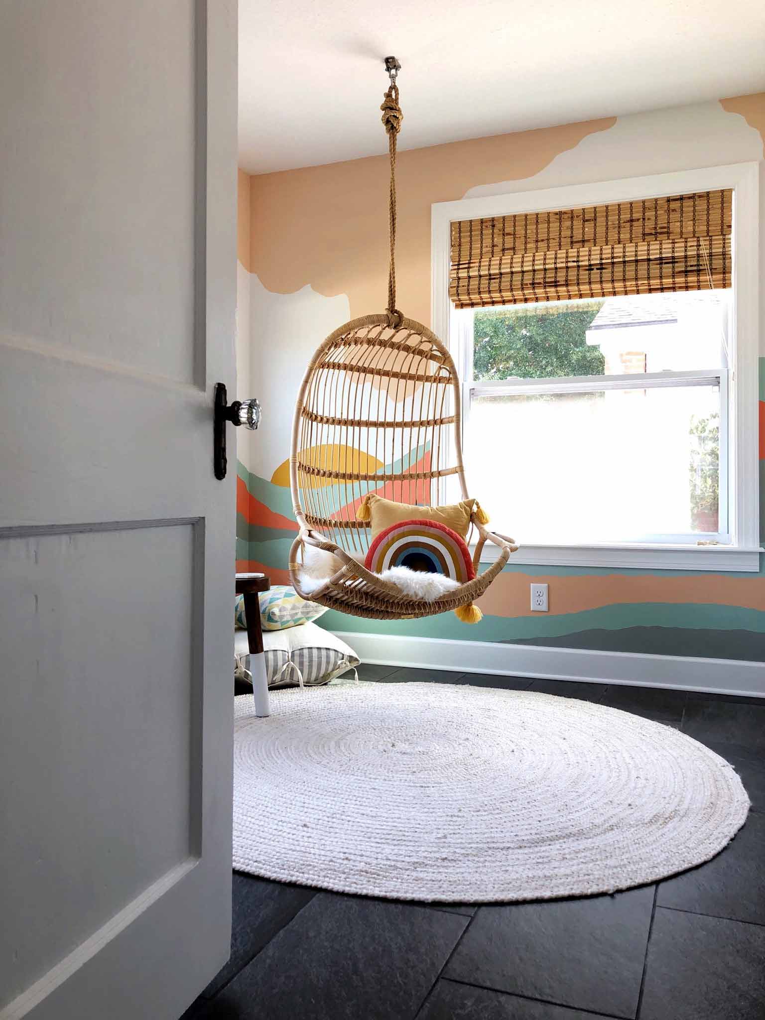 playroom with colorful mural and hanging chair