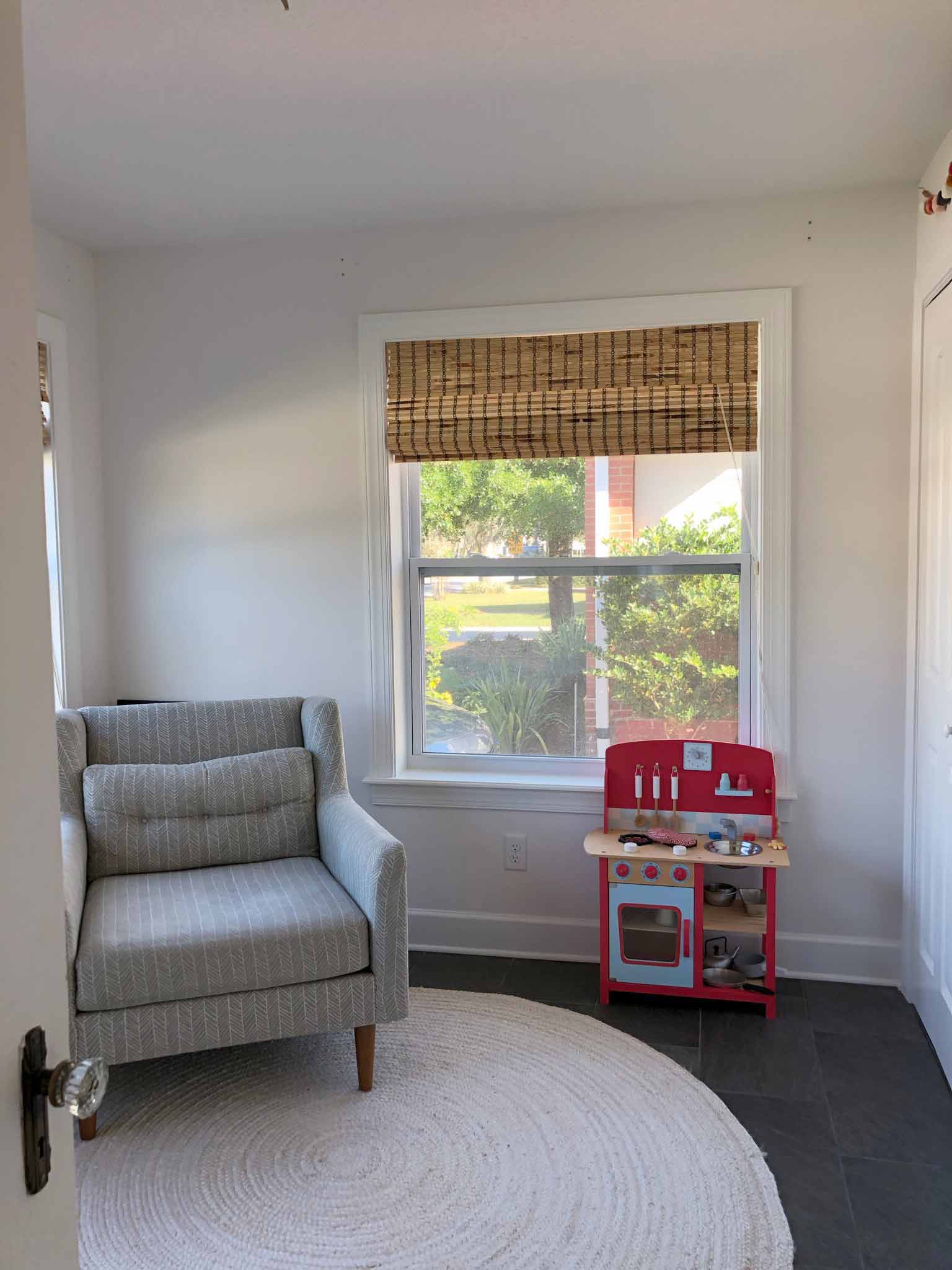 room with round rug and gray armchair