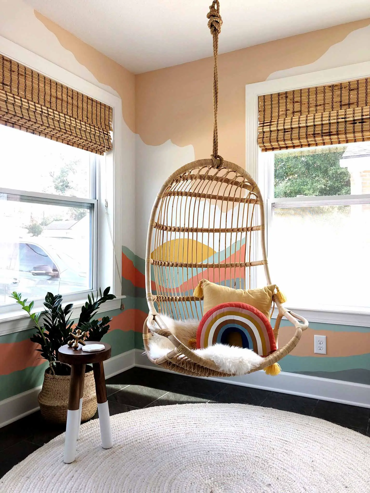 playroom with colorful mural and hanging chair