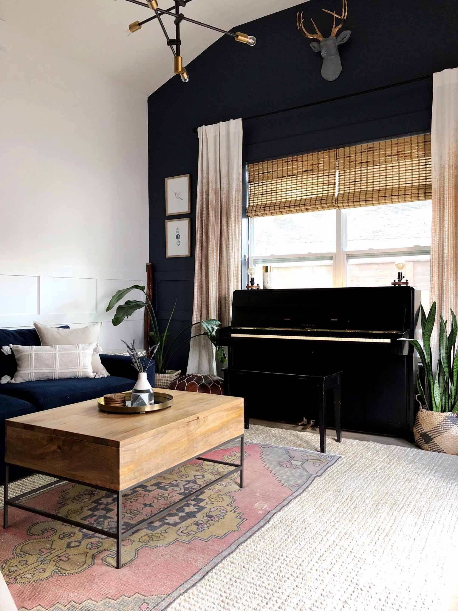 room with navy accent wall and high ceiling