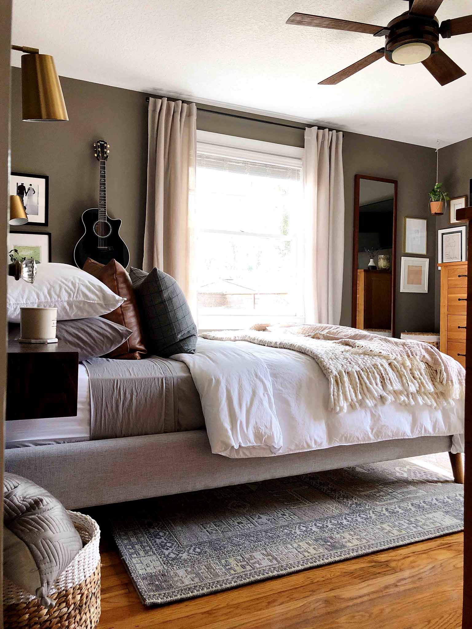 neutral master bedroom with upholstered bed