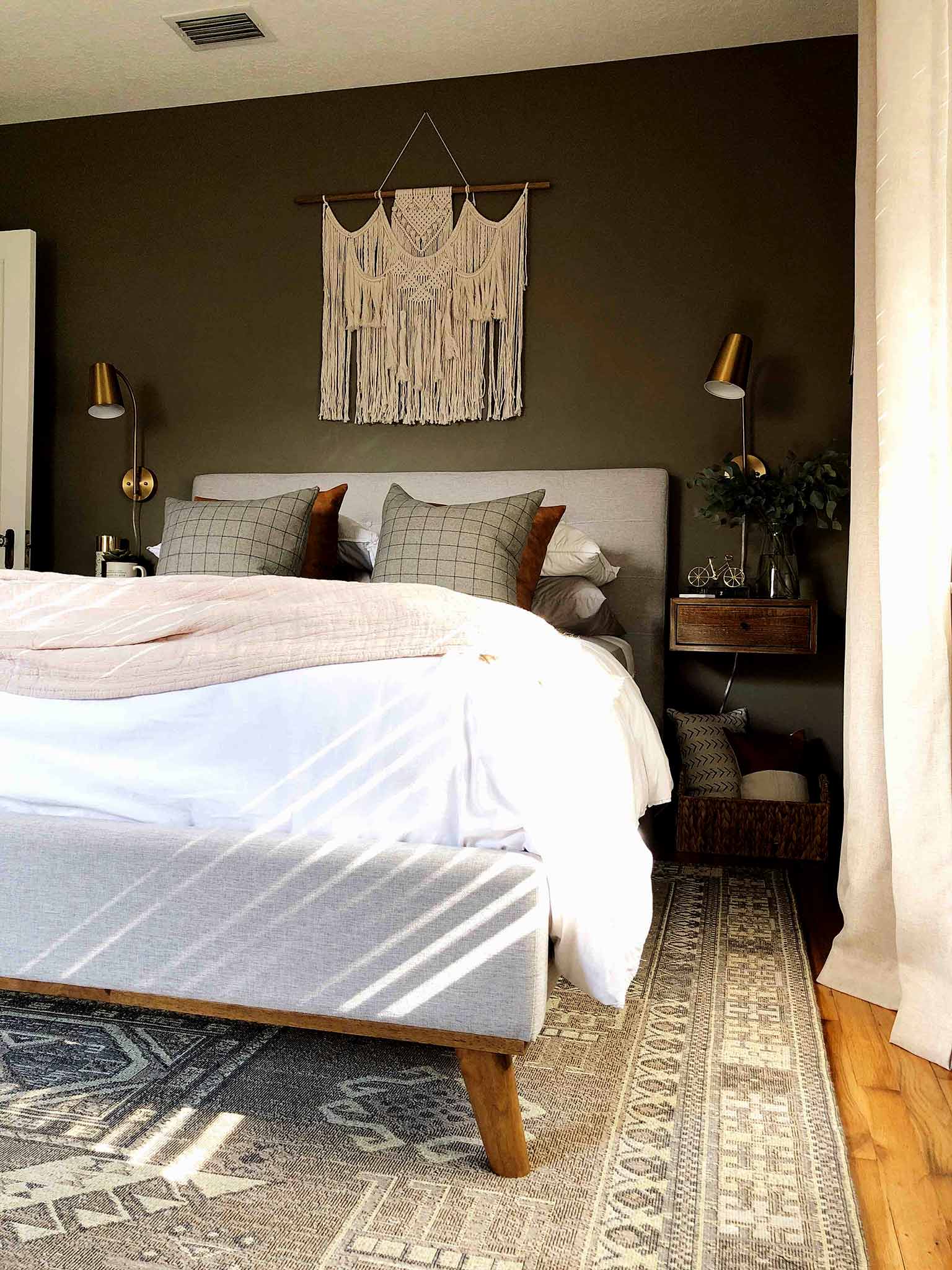 neutral master bedroom with upholstered bed