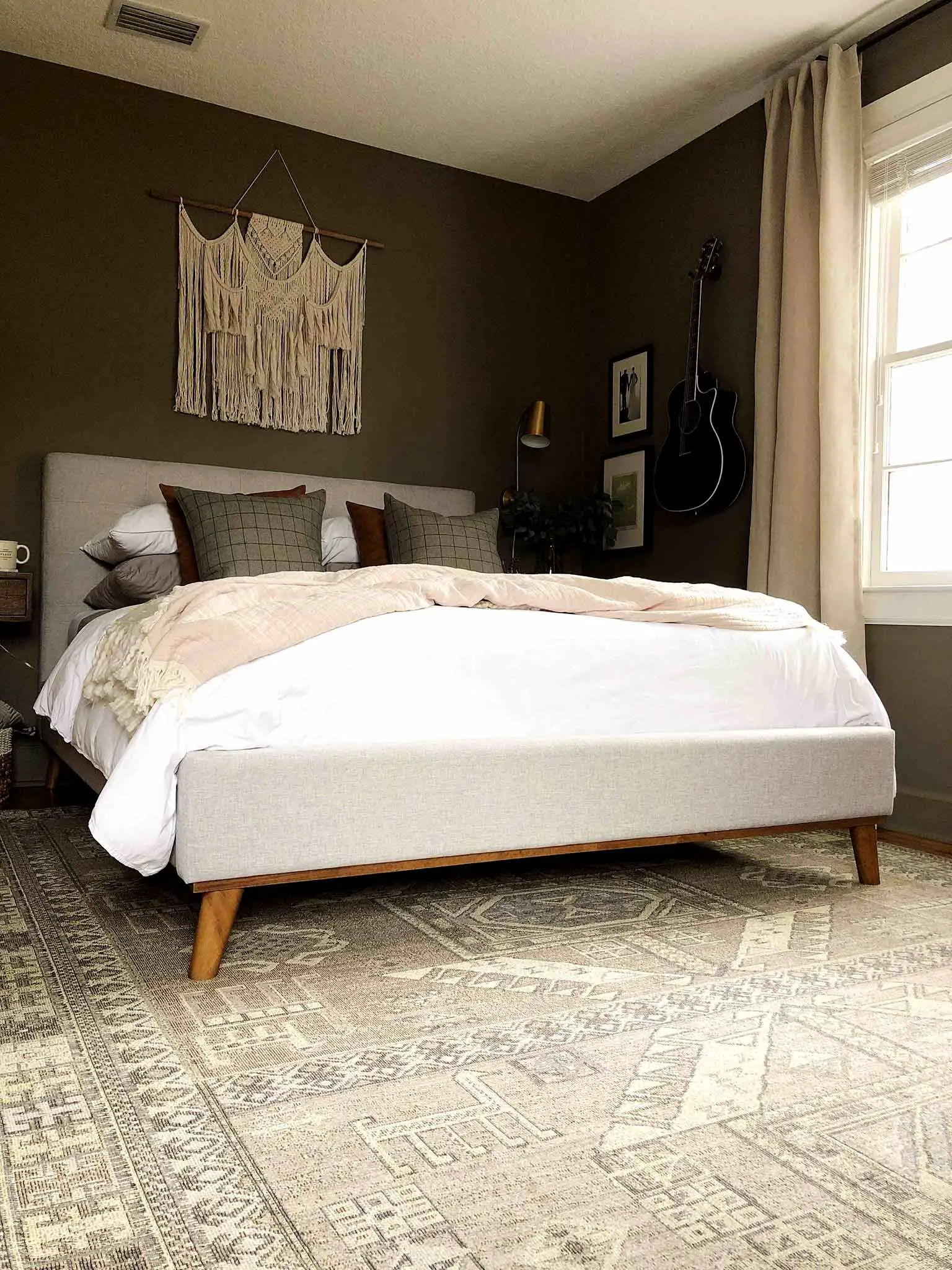 neutral master bedroom with upholstered bed