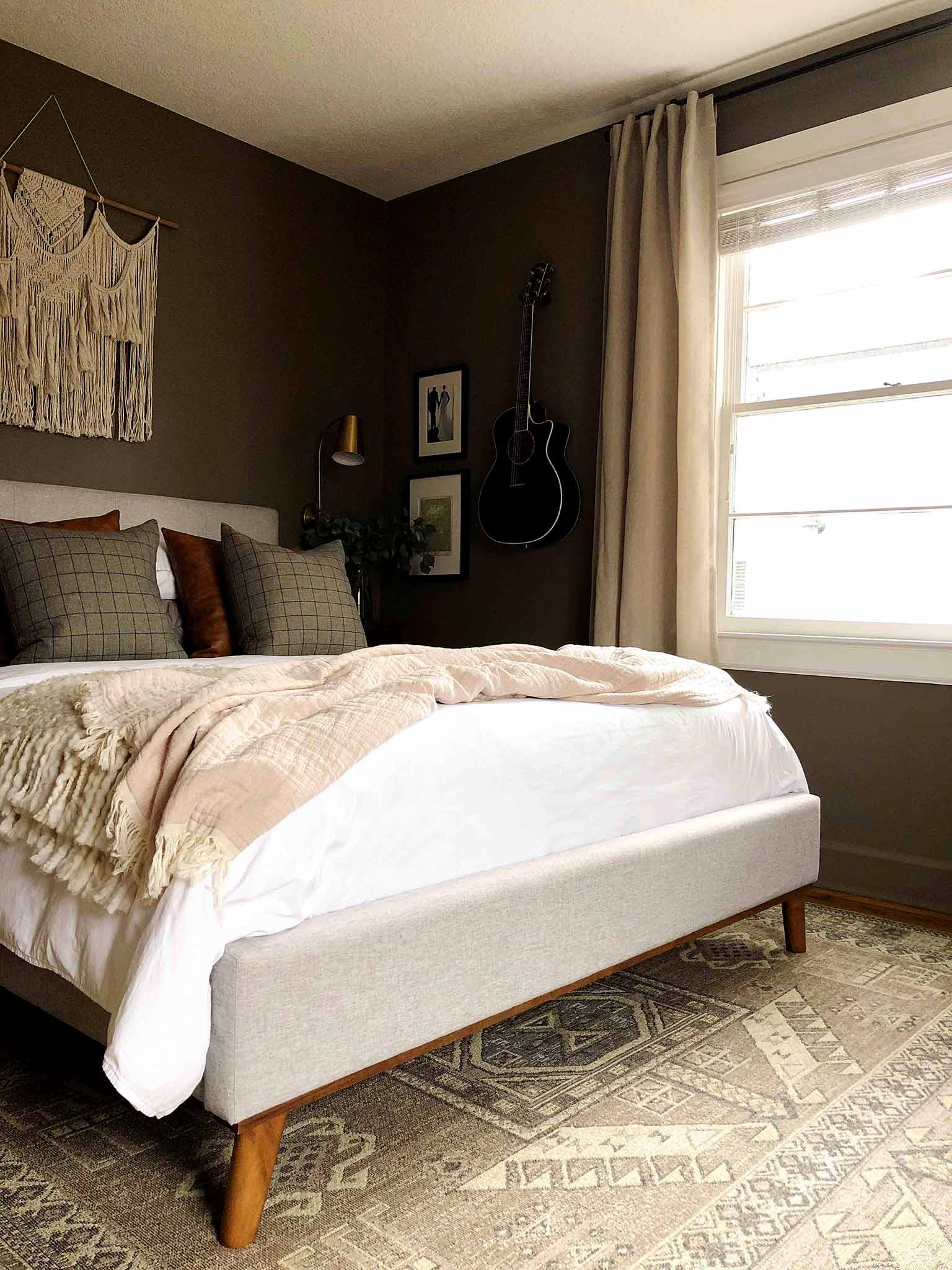 neutral master bedroom with upholstered bed