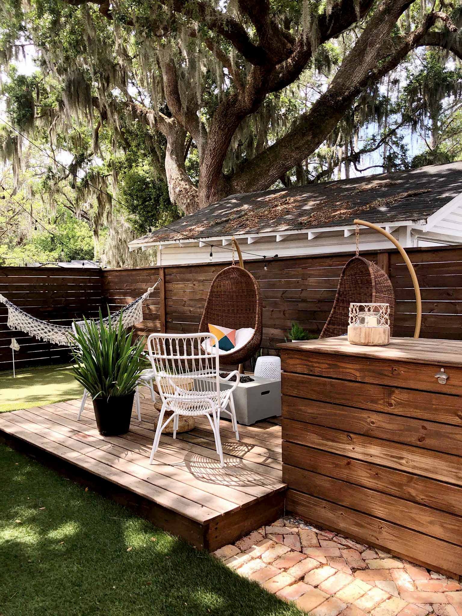 deck with hanging chairs and hammock