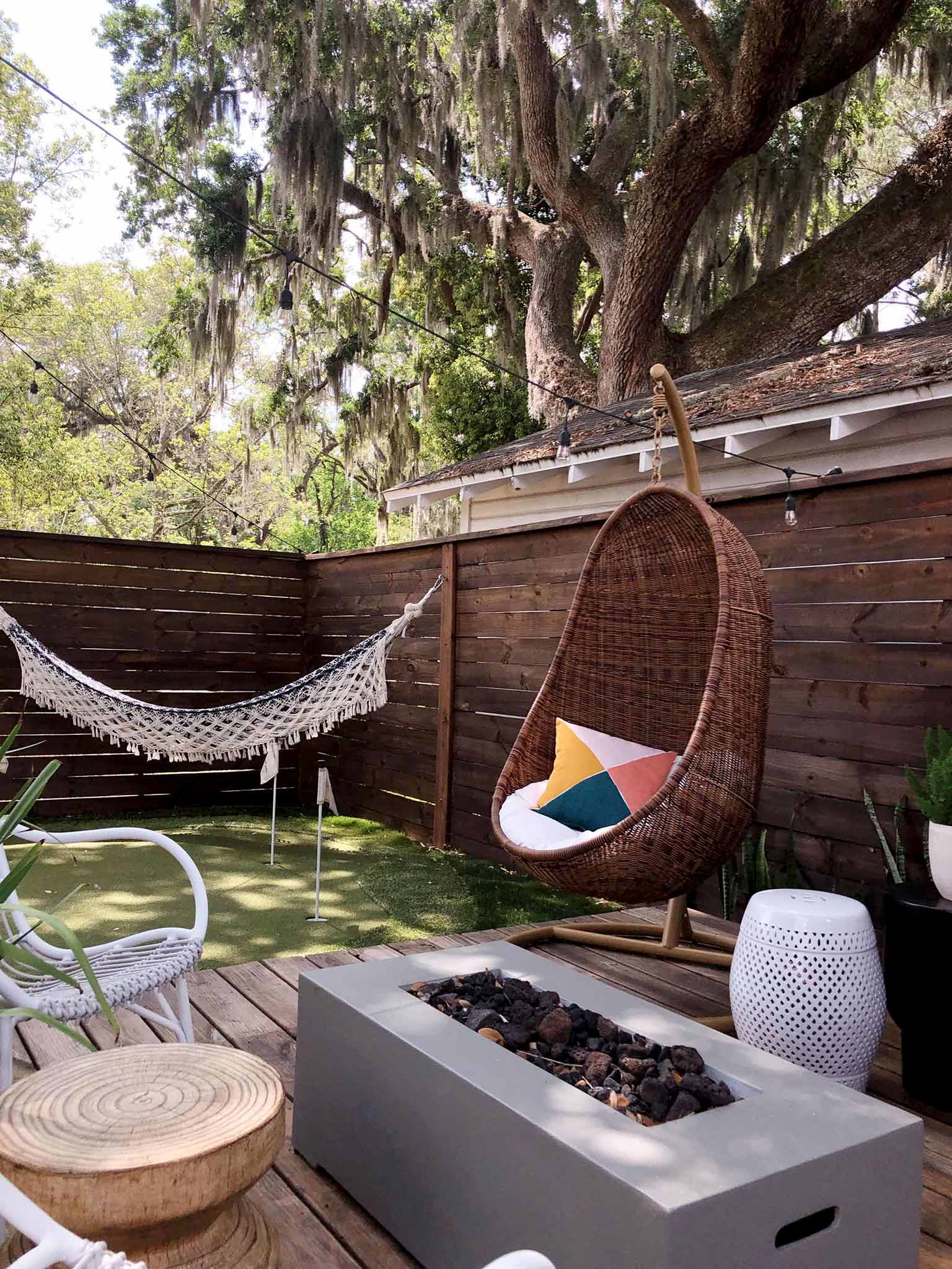 deck with hanging chairs and hammock