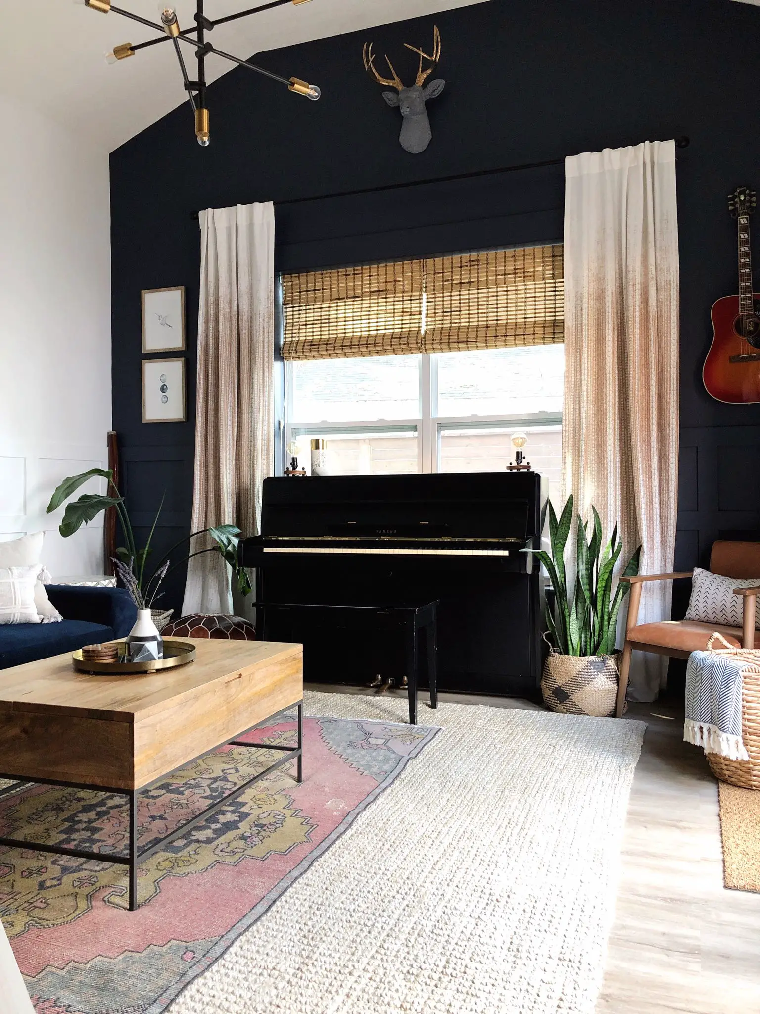 room with layered rugs with navy wall