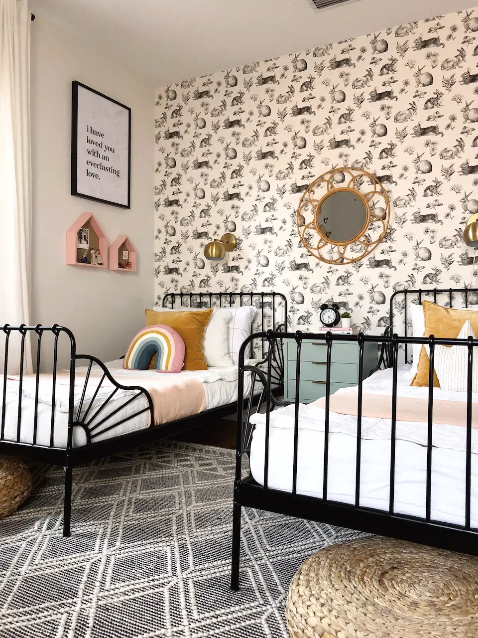 shared girls bedroom with twin beds and rabbit wallpaper