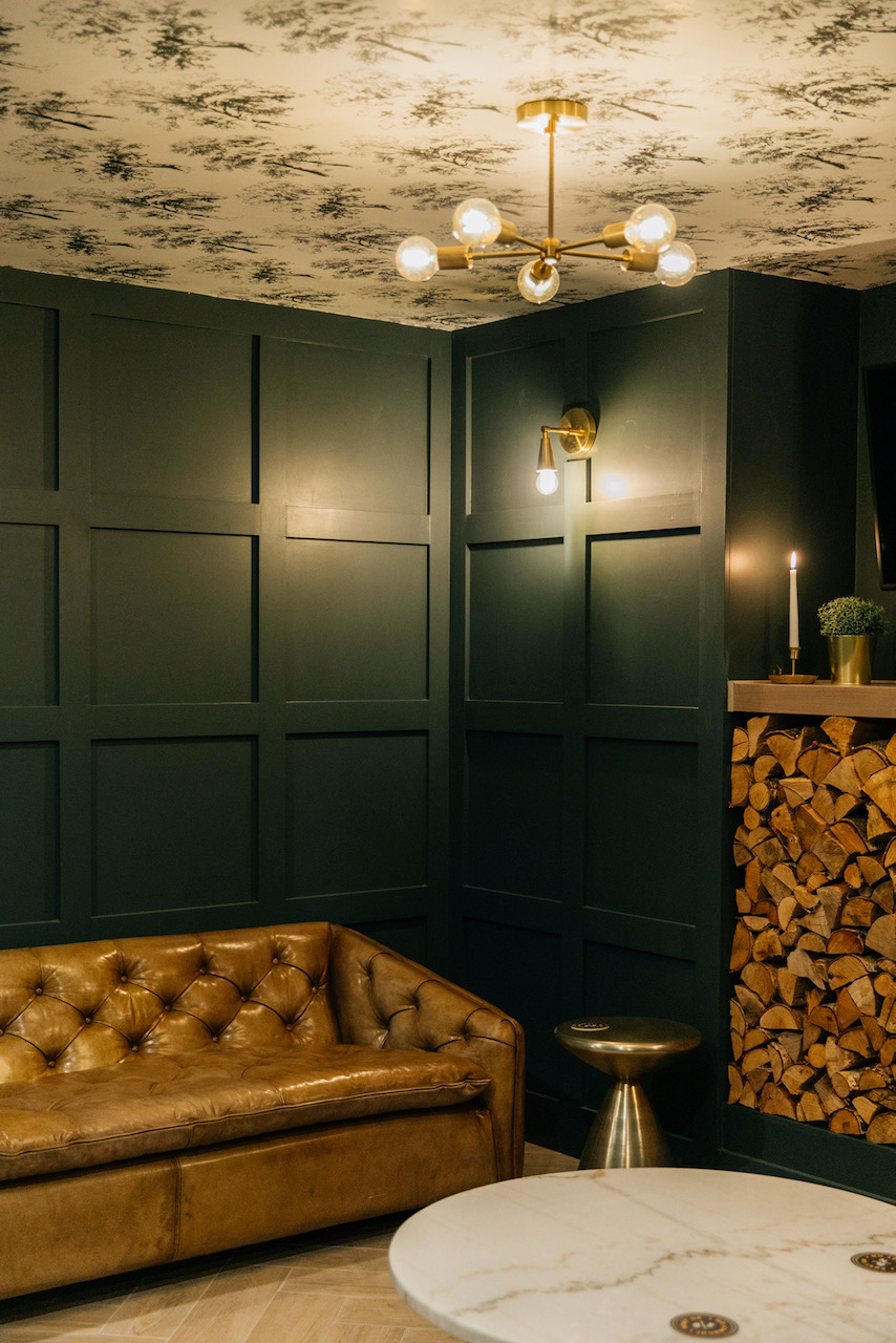 Paneled room with wallpaper on the ceiling