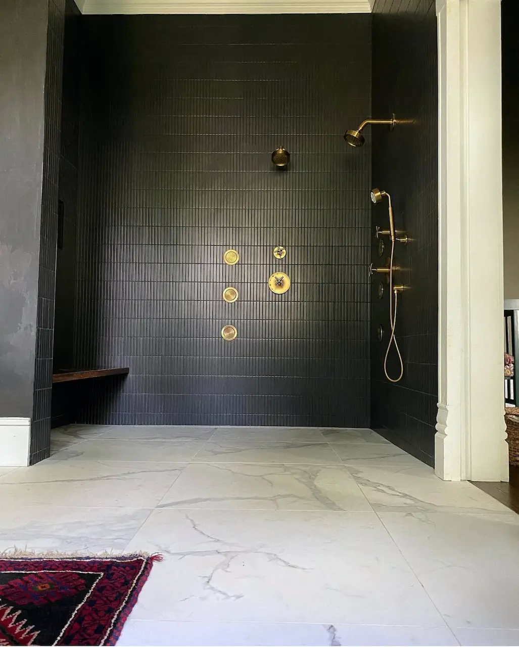 large shower with black mosaic tile