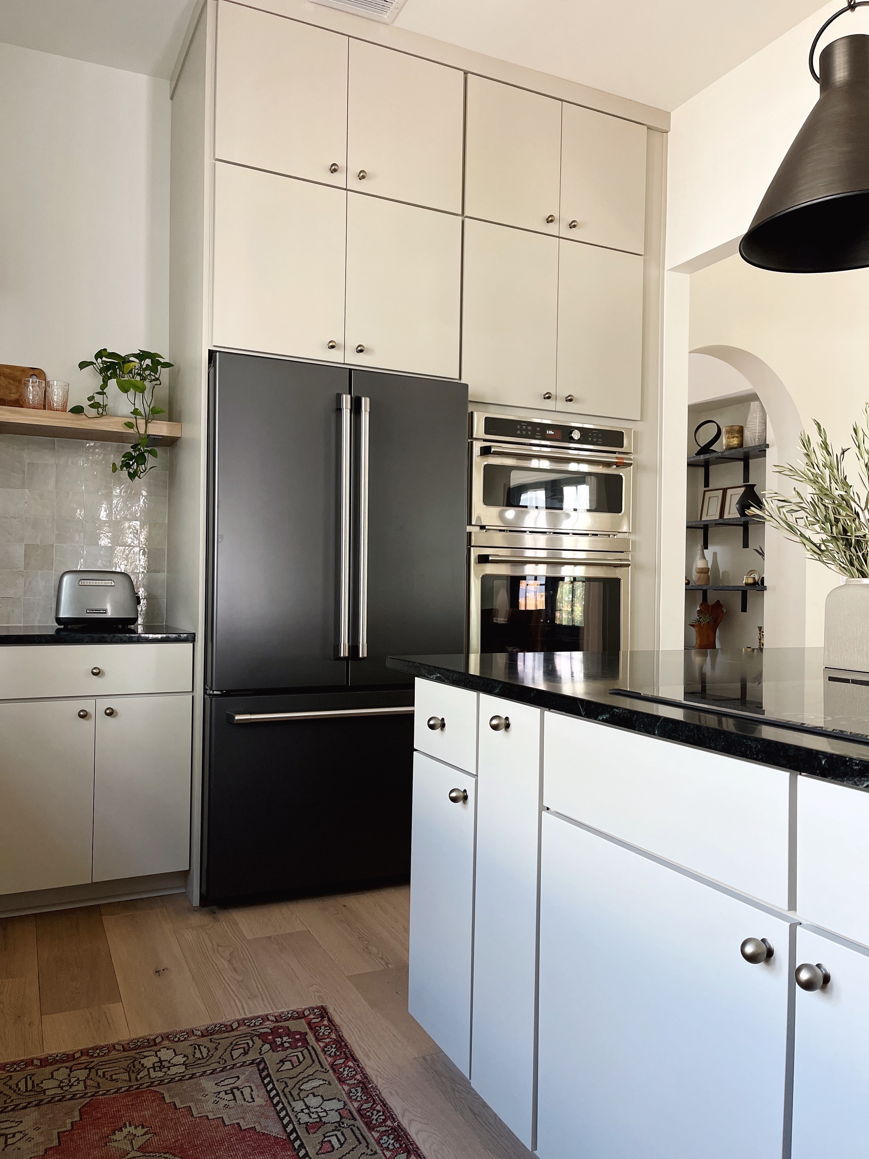 organic modern style kitchen with greige cabinets and soapstone countertops