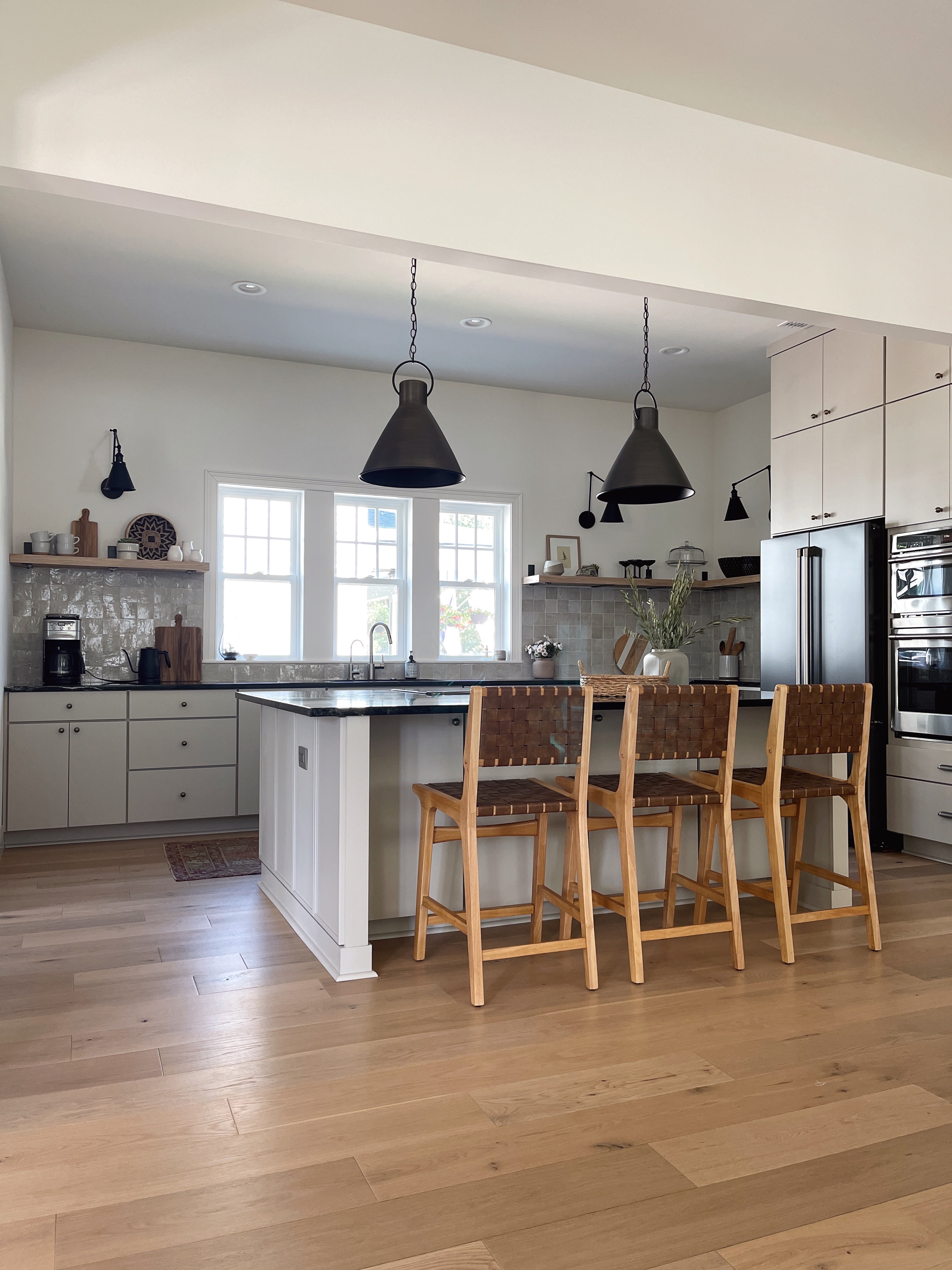 organic modern style kitchen with greige cabinets and soapstone countertops