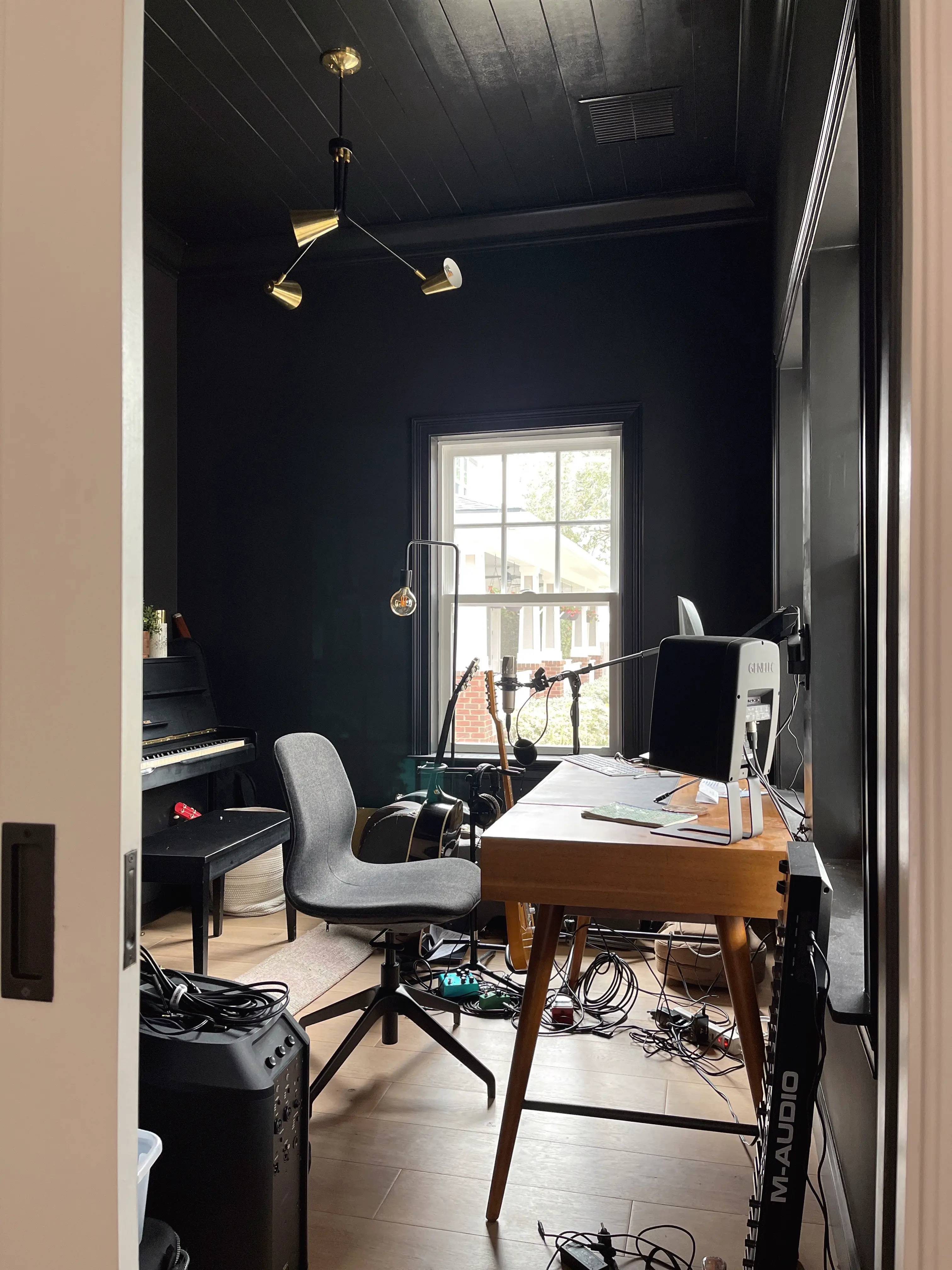 home office with black walls and ceiling