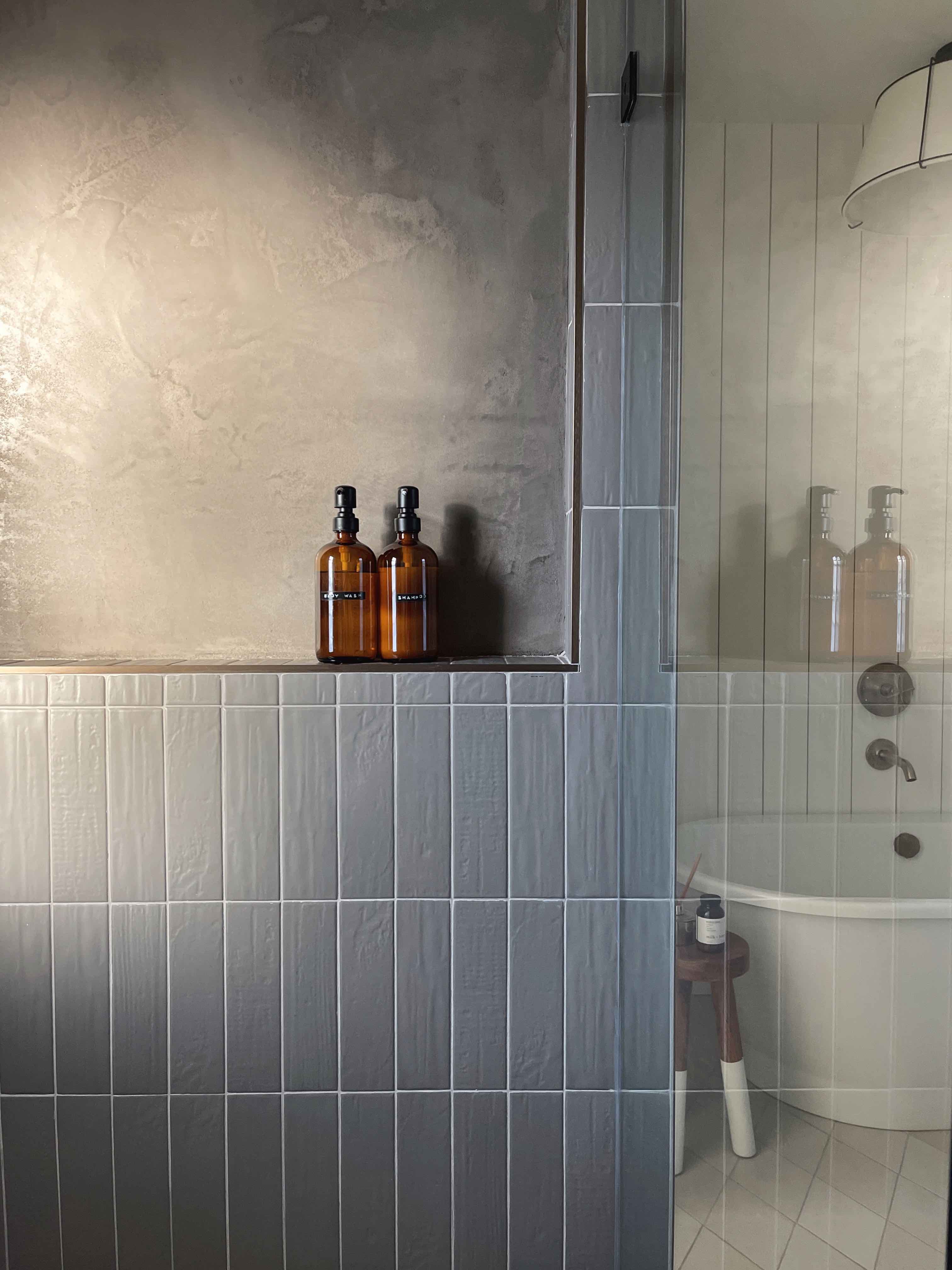 shower with vertical stacked tile and tadelakt plaster